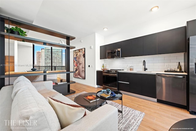 living room with sink and light hardwood / wood-style flooring