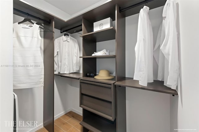 walk in closet with light wood-type flooring