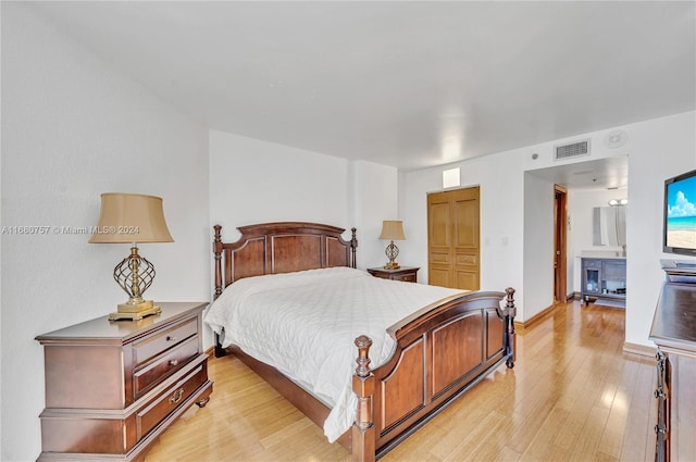 bedroom with light hardwood / wood-style flooring and a closet