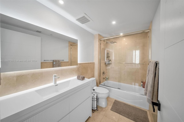 full bathroom with vanity, toilet, tile patterned floors, and tiled shower / bath combo