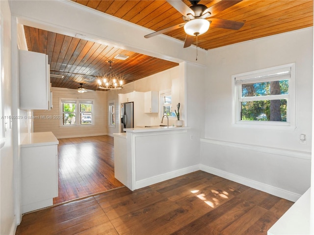 kitchen with stainless steel fridge with ice dispenser, light countertops, baseboards, wood ceiling, and dark wood-style flooring