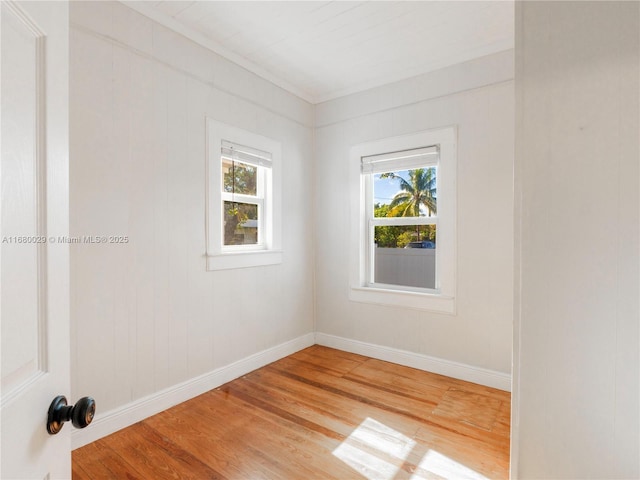 empty room with wood finished floors and baseboards