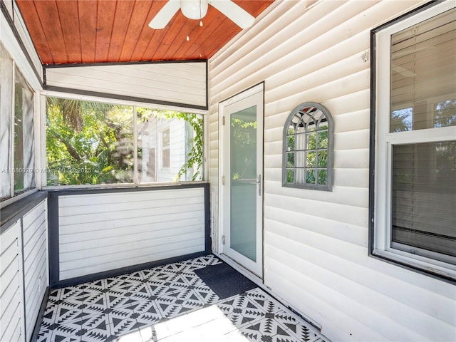 exterior space with log veneer siding and ceiling fan