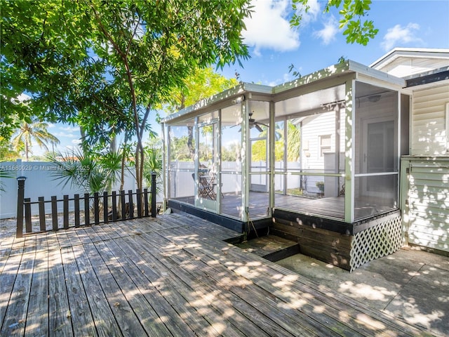 wooden deck with a sunroom