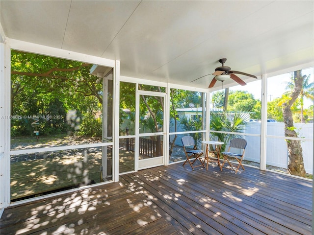 unfurnished sunroom with a ceiling fan