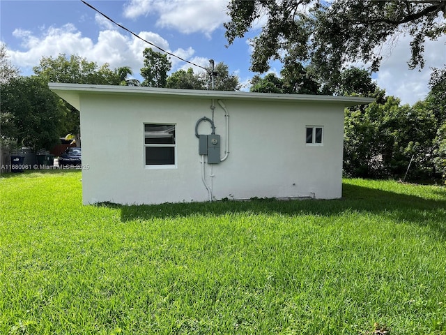 view of home's exterior with a yard and stucco siding