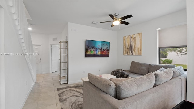 tiled living room with ceiling fan