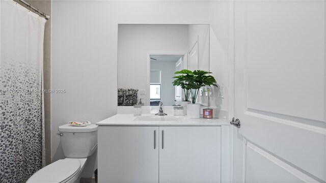 bathroom with vanity, toilet, a shower with curtain, and tile patterned flooring