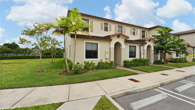 mediterranean / spanish-style home with a front yard