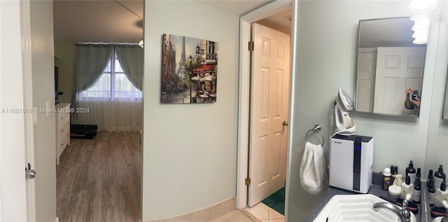 bathroom with hardwood / wood-style floors and sink