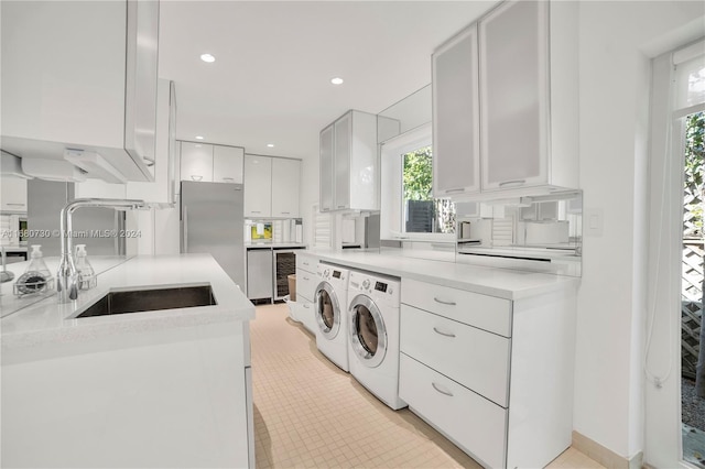 laundry room with sink and separate washer and dryer