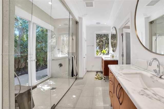 bathroom with vanity, crown molding, walk in shower, and a wealth of natural light