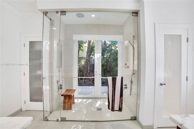 bathroom featuring french doors and a shower with shower door