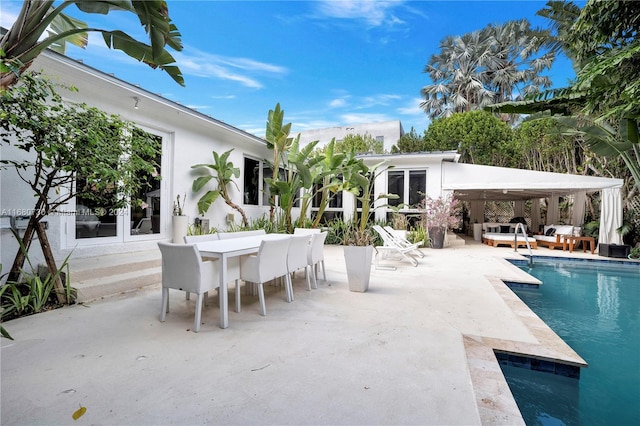 view of swimming pool with a gazebo, a patio area, a hot tub, and an outdoor living space