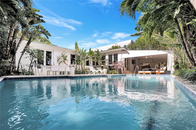 view of swimming pool with a patio and ceiling fan