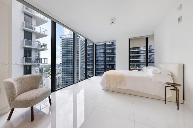 bedroom with expansive windows and tile patterned flooring