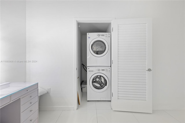 laundry room with stacked washer and dryer and light tile patterned floors