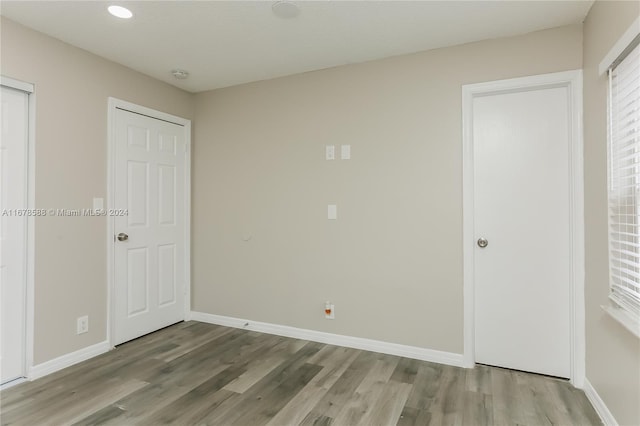 unfurnished bedroom with light hardwood / wood-style floors