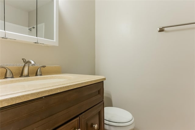 bathroom featuring toilet and vanity