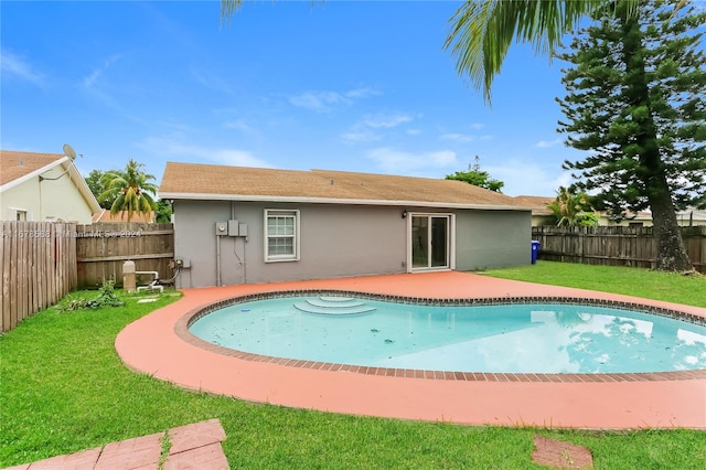 view of swimming pool with a patio area and a lawn