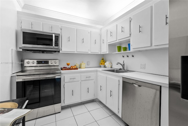 kitchen featuring white cabinets, sink, light tile patterned floors, and stainless steel appliances