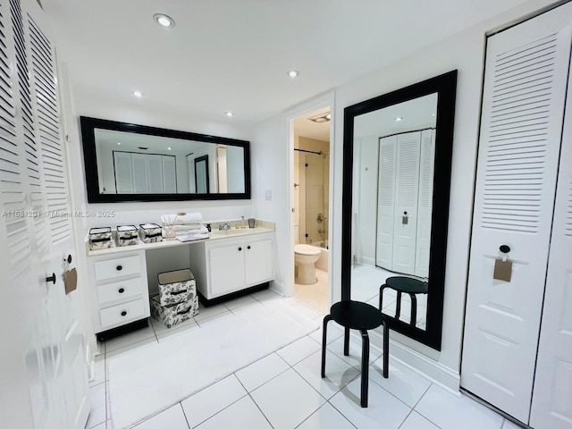 full bathroom featuring a closet, tile patterned flooring, vanity, and toilet