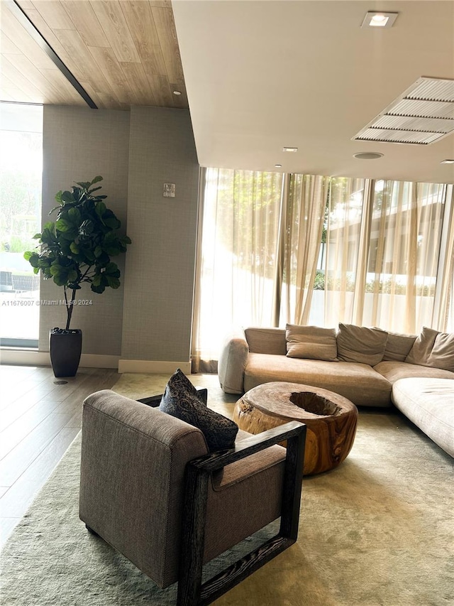 living room featuring wood ceiling, a healthy amount of sunlight, and hardwood / wood-style flooring