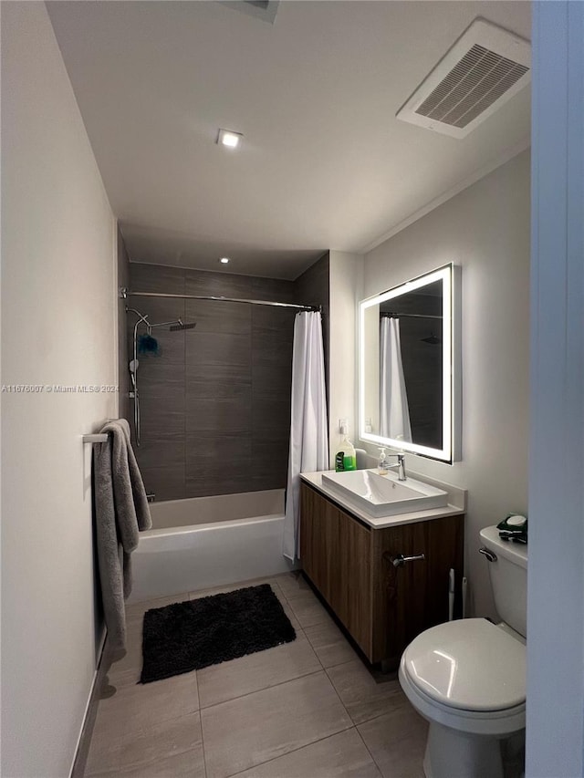 full bathroom featuring vanity, shower / bath combo with shower curtain, toilet, and tile patterned flooring