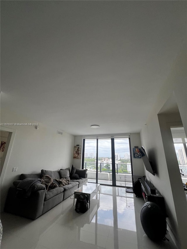 living room with floor to ceiling windows, light tile patterned floors, and plenty of natural light