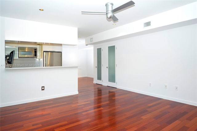 unfurnished living room with ceiling fan and dark hardwood / wood-style flooring