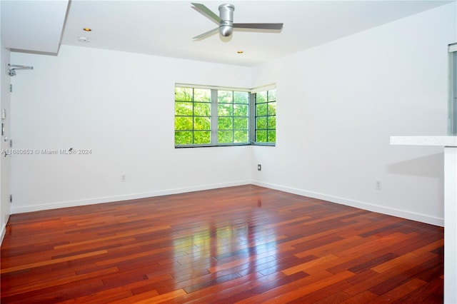 spare room with dark hardwood / wood-style floors and ceiling fan