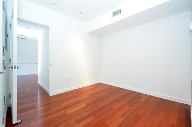 spare room with wood-type flooring