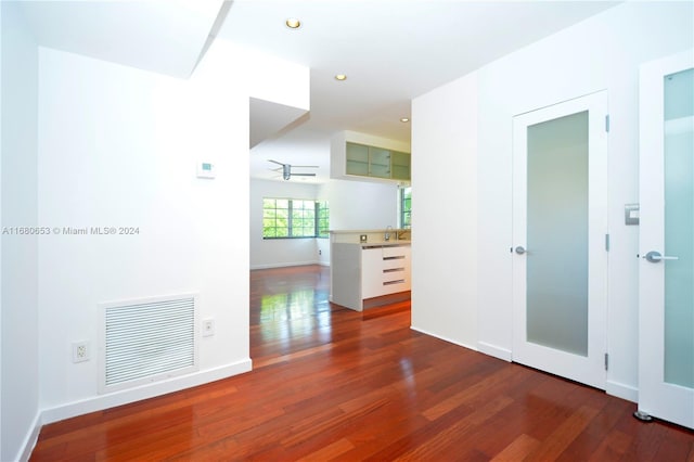 empty room featuring sink and dark hardwood / wood-style flooring