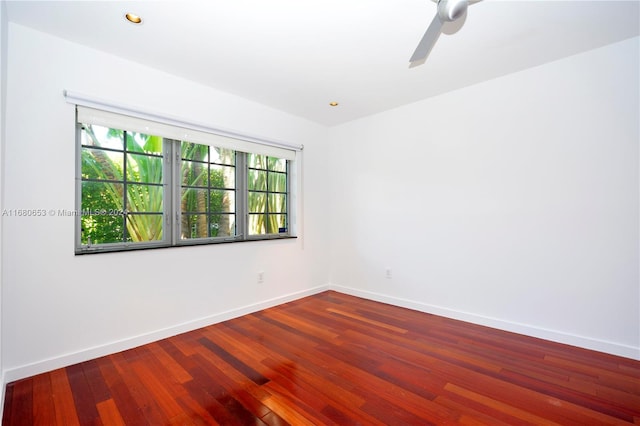 spare room featuring hardwood / wood-style floors and ceiling fan