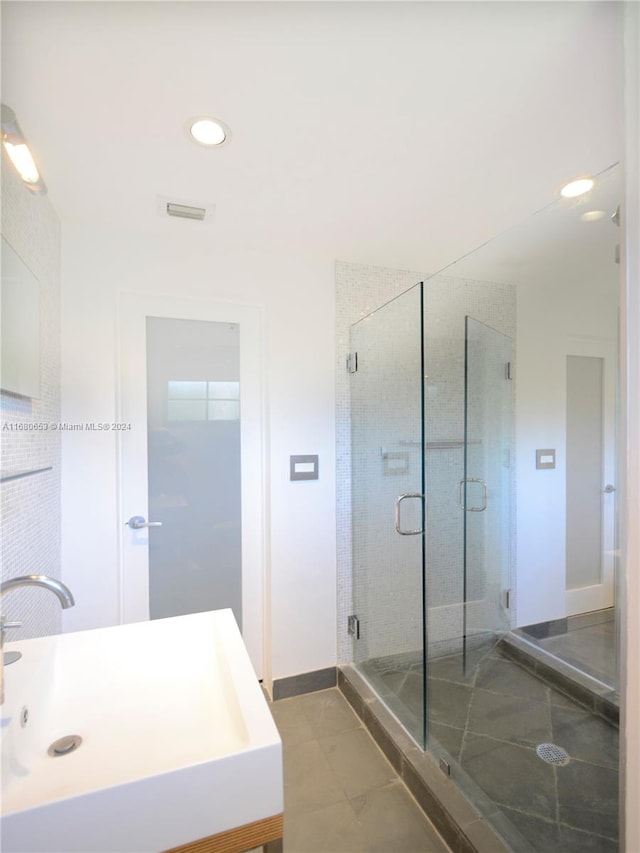 bathroom featuring vanity, tile patterned floors, and an enclosed shower