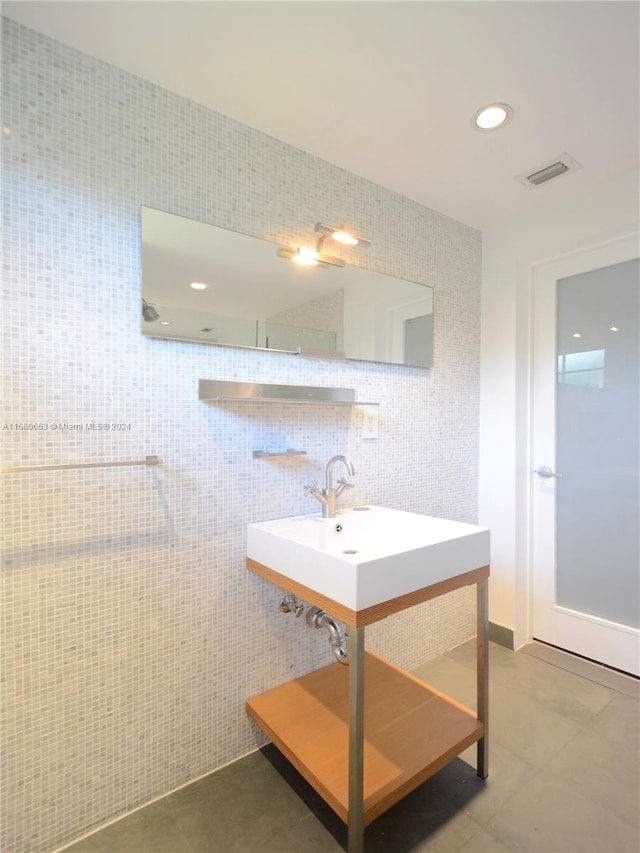 bathroom featuring sink, tile walls, and tile patterned flooring