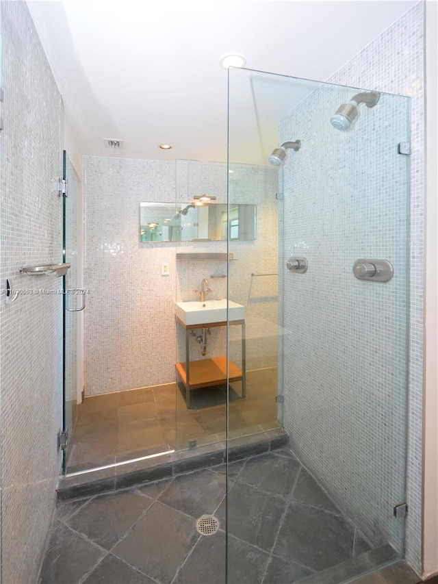 bathroom with tile walls and walk in shower