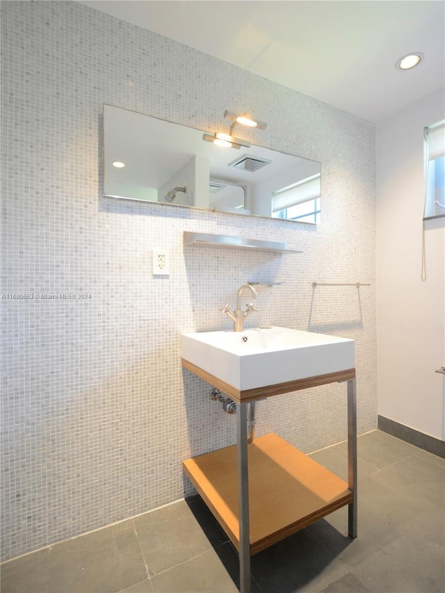 bathroom featuring tile patterned floors, tile walls, and a wealth of natural light