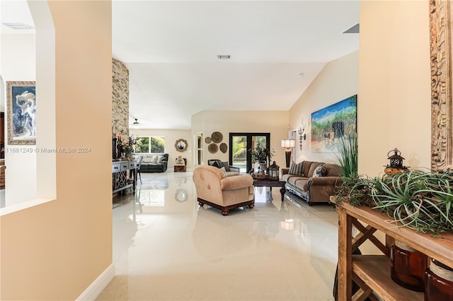 living room featuring vaulted ceiling, tile patterned floors, and ceiling fan