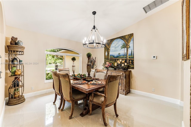 dining space with light tile patterned floors and a notable chandelier