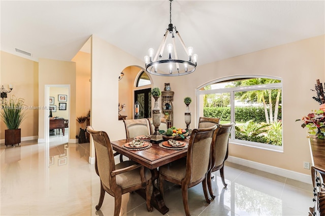 tiled dining space with a notable chandelier