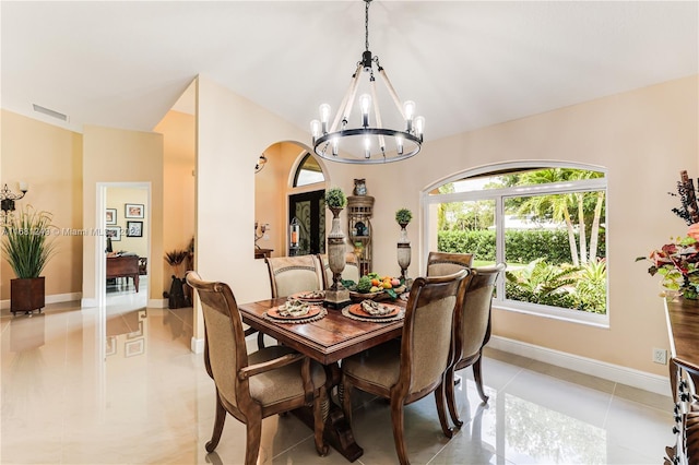 12288 N 82nd Ln N, West Palm Beach, FL 33412 - dining room featuring a chandelier, light tile patterned floors, lofted ceiling, and baseboards