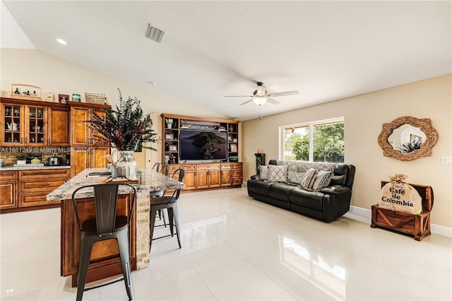 12288 N 82nd Ln N, West Palm Beach, FL 33412 - living area featuring vaulted ceiling, a ceiling fan, and light tile patterned floors