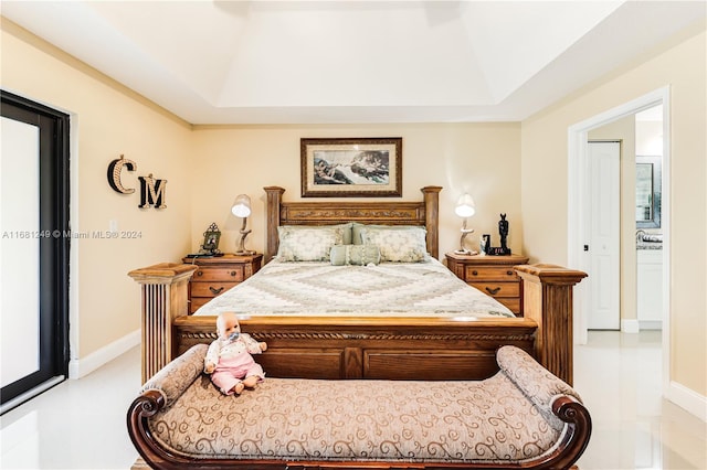12288 N 82nd Ln N, West Palm Beach, FL 33412 - bedroom with a tray ceiling, tile patterned flooring, and baseboards