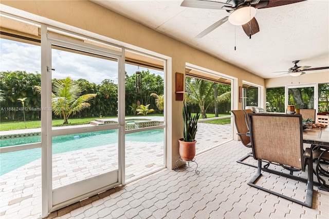 sunroom / solarium with ceiling fan