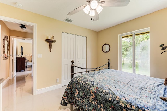 tiled bedroom with a closet, ceiling fan, and access to exterior