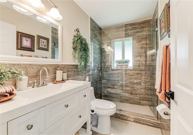 bathroom with tile patterned floors, toilet, a shower with door, decorative backsplash, and vanity