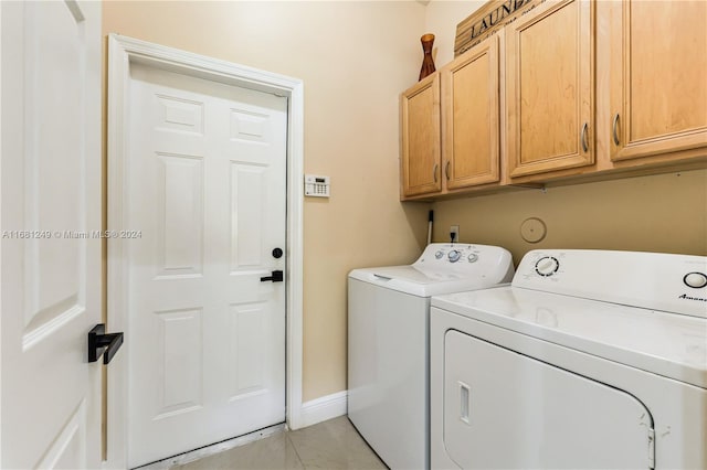 laundry room featuring cabinets and separate washer and dryer