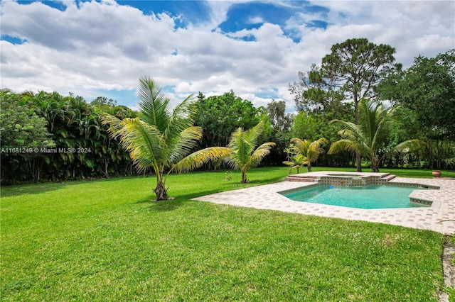 12288 N 82nd Ln N, West Palm Beach, FL 33412 - view of swimming pool featuring a yard, a pool with connected hot tub, and a patio