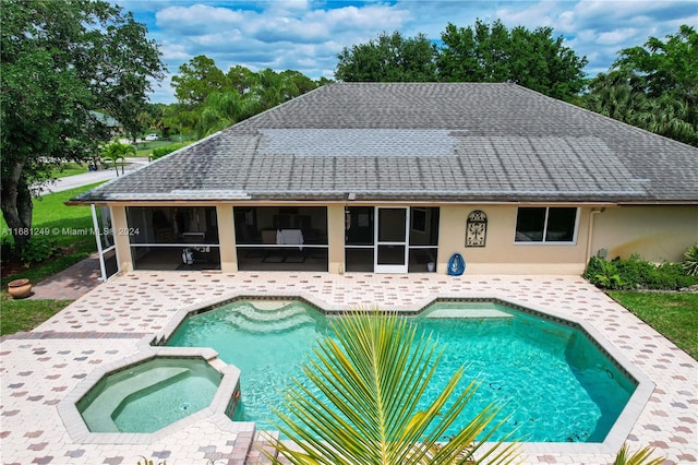 12288 N 82nd Ln N, West Palm Beach, FL 33412 - view of swimming pool featuring a sunroom, a patio area, and a pool with connected hot tub